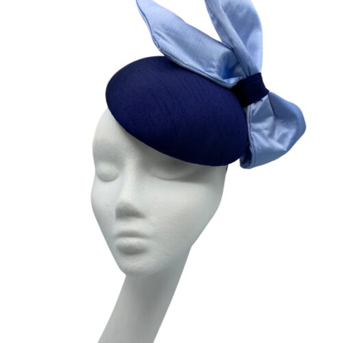 Stunning navy raw silk base headpiece with a beautiful raw silk steel blue side bow to finish.